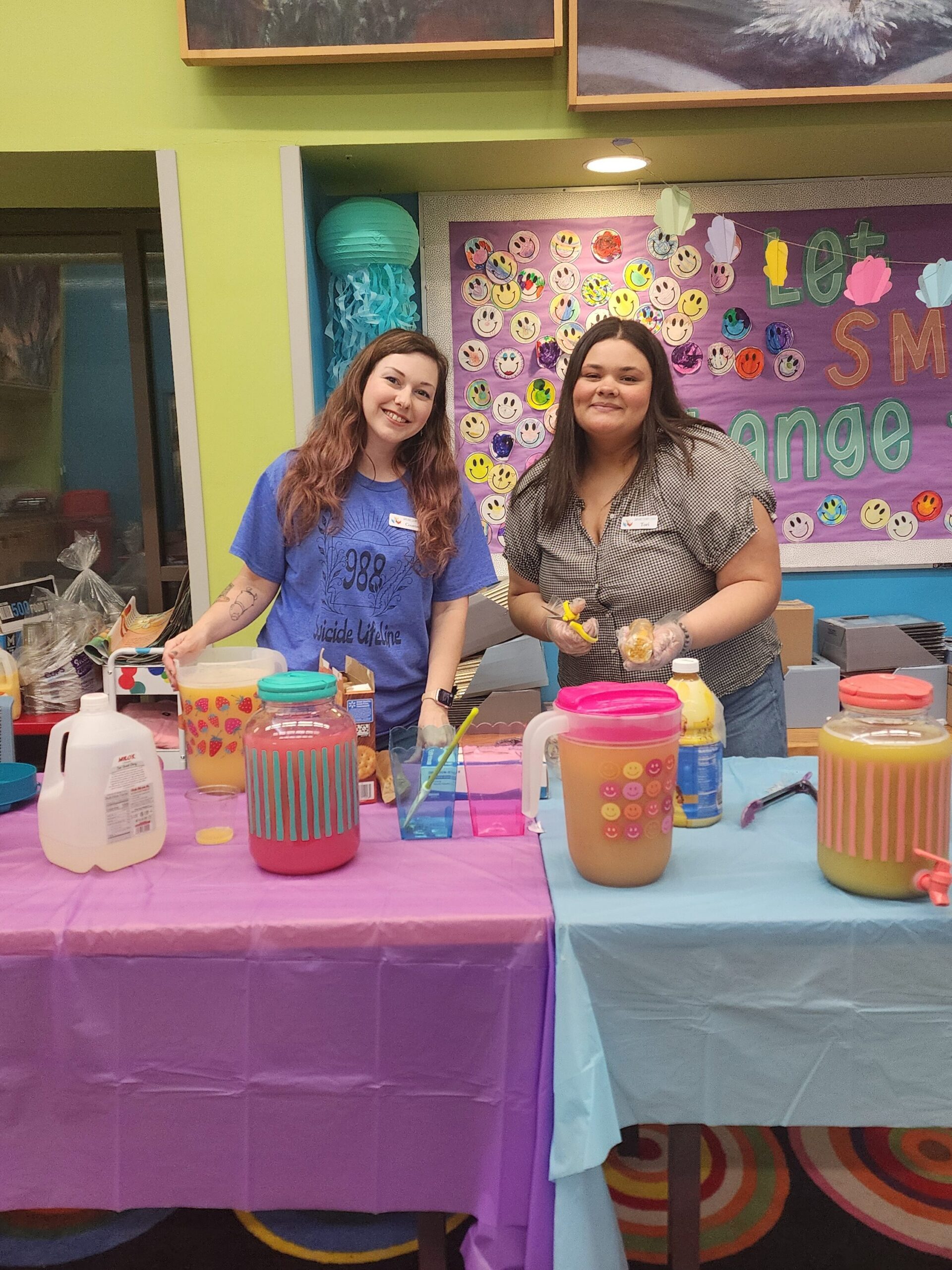 Courtney and Tori pose with snacks at a library program