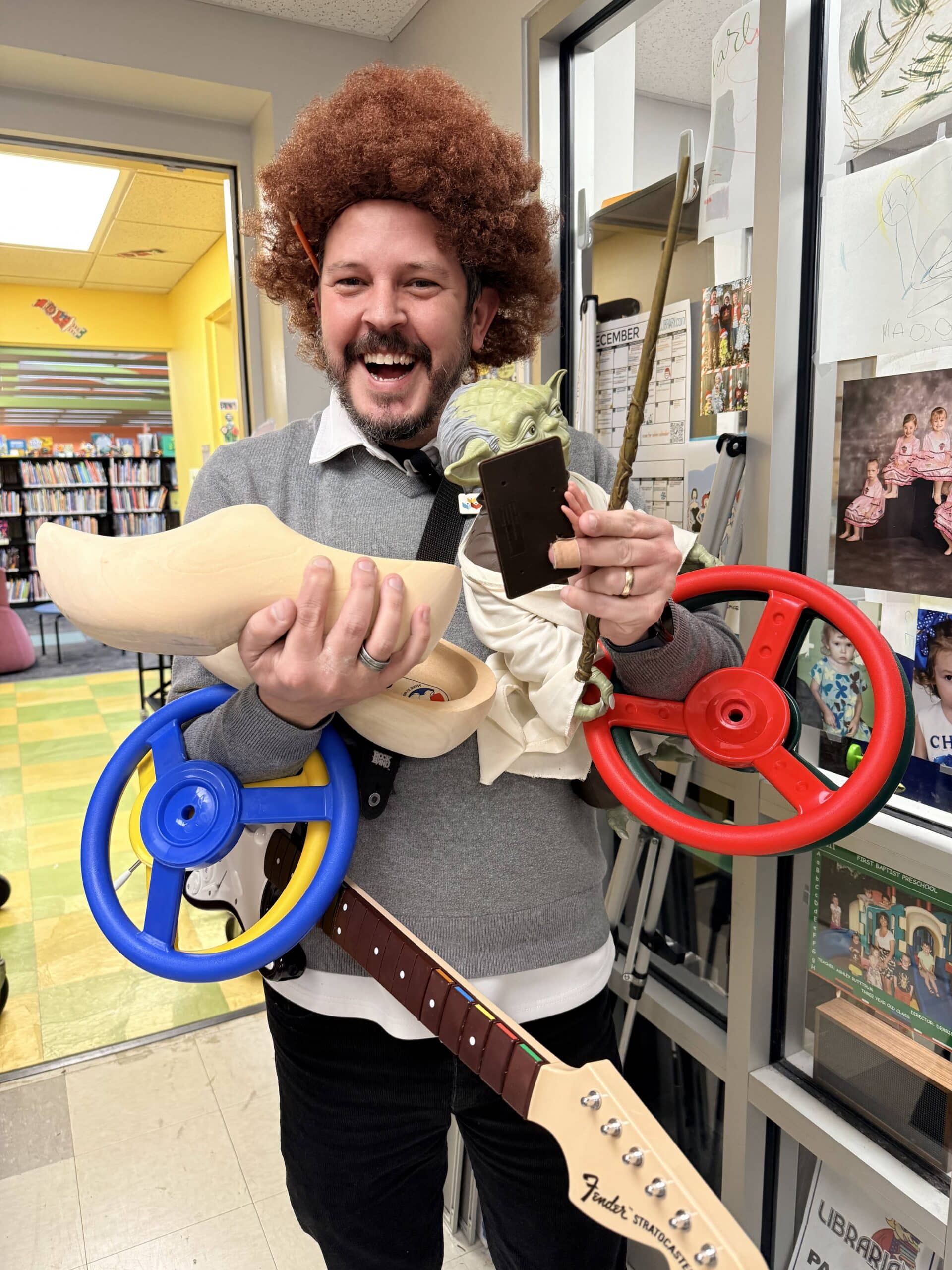 Technical Services Librarian, Brent, holds some strange things found in the Children's Department