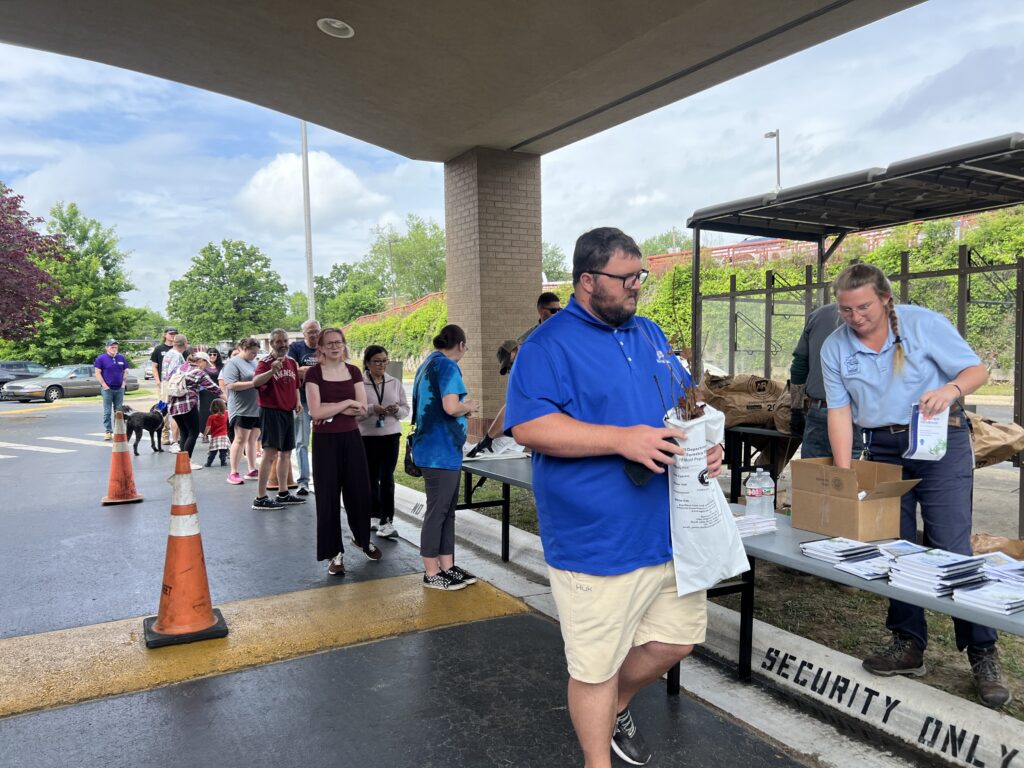 Patrons line up to receive free tree saplings from the City of Hot Springs in honor of Arbor Day.