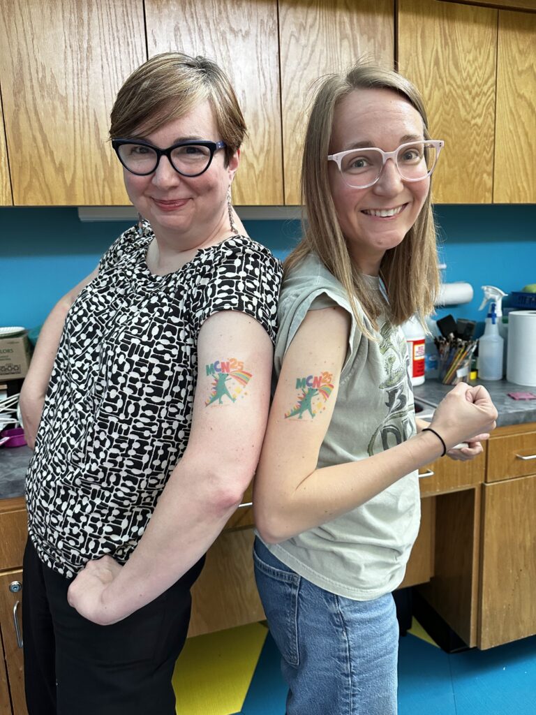 Tiffany and Katie pose with fake tattoos.