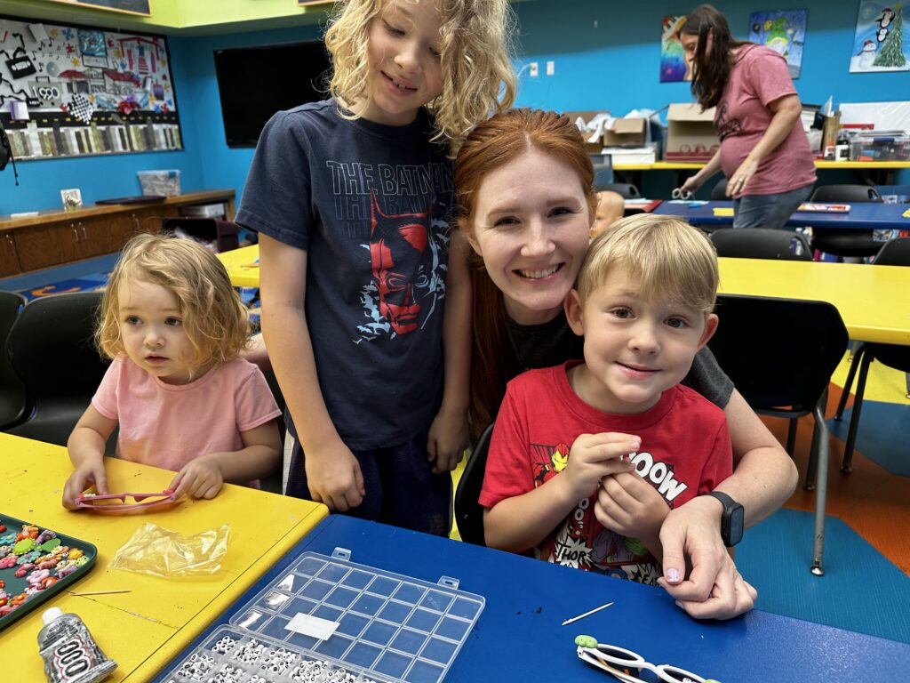 Family enjoys a crafting program in the Library multipurpose meeting room.