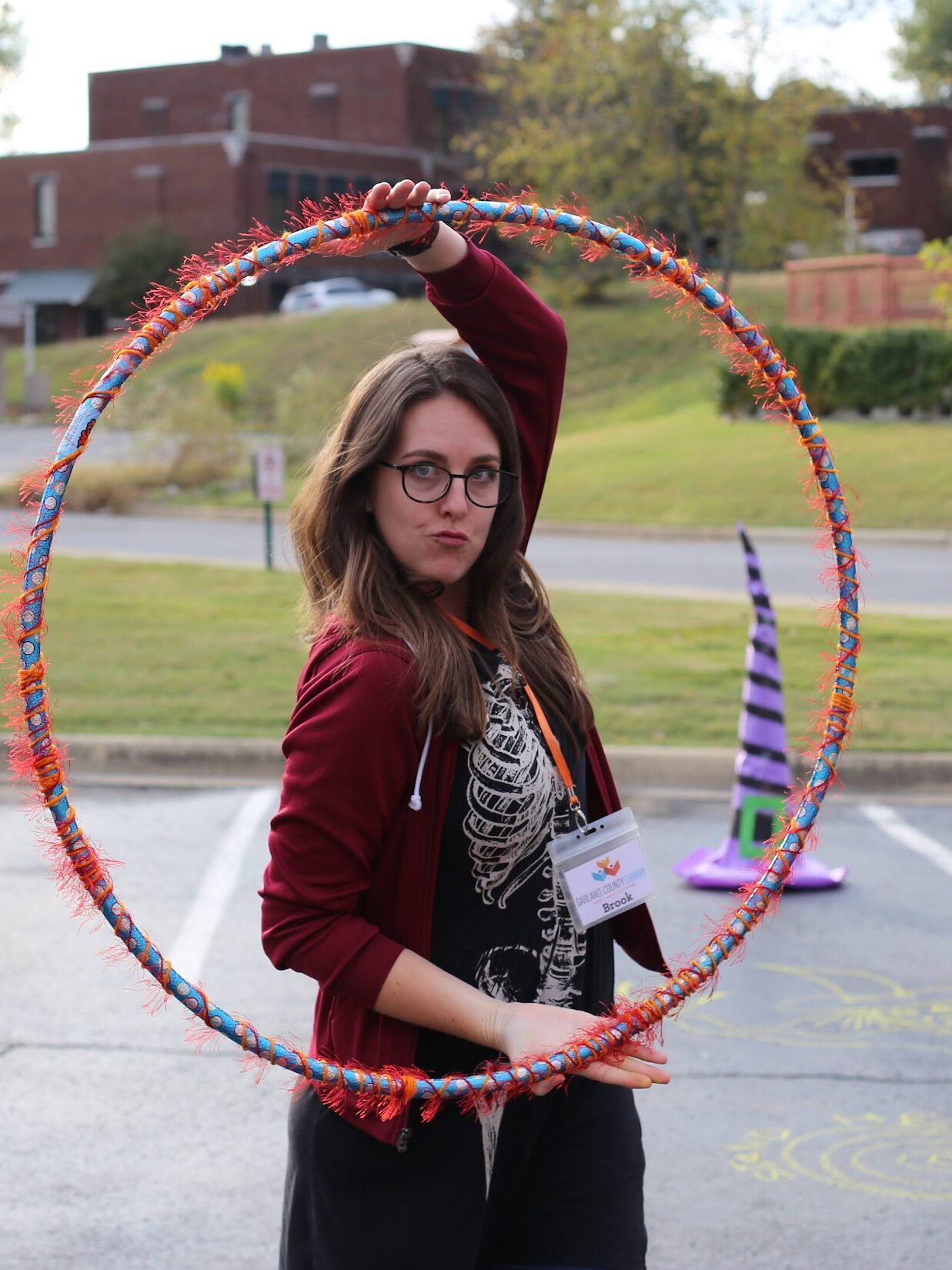 Brook poses with hula hoop at library program