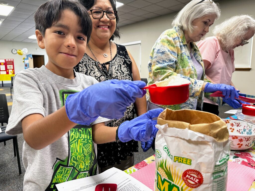 A young patron measures materials for a science experiment.