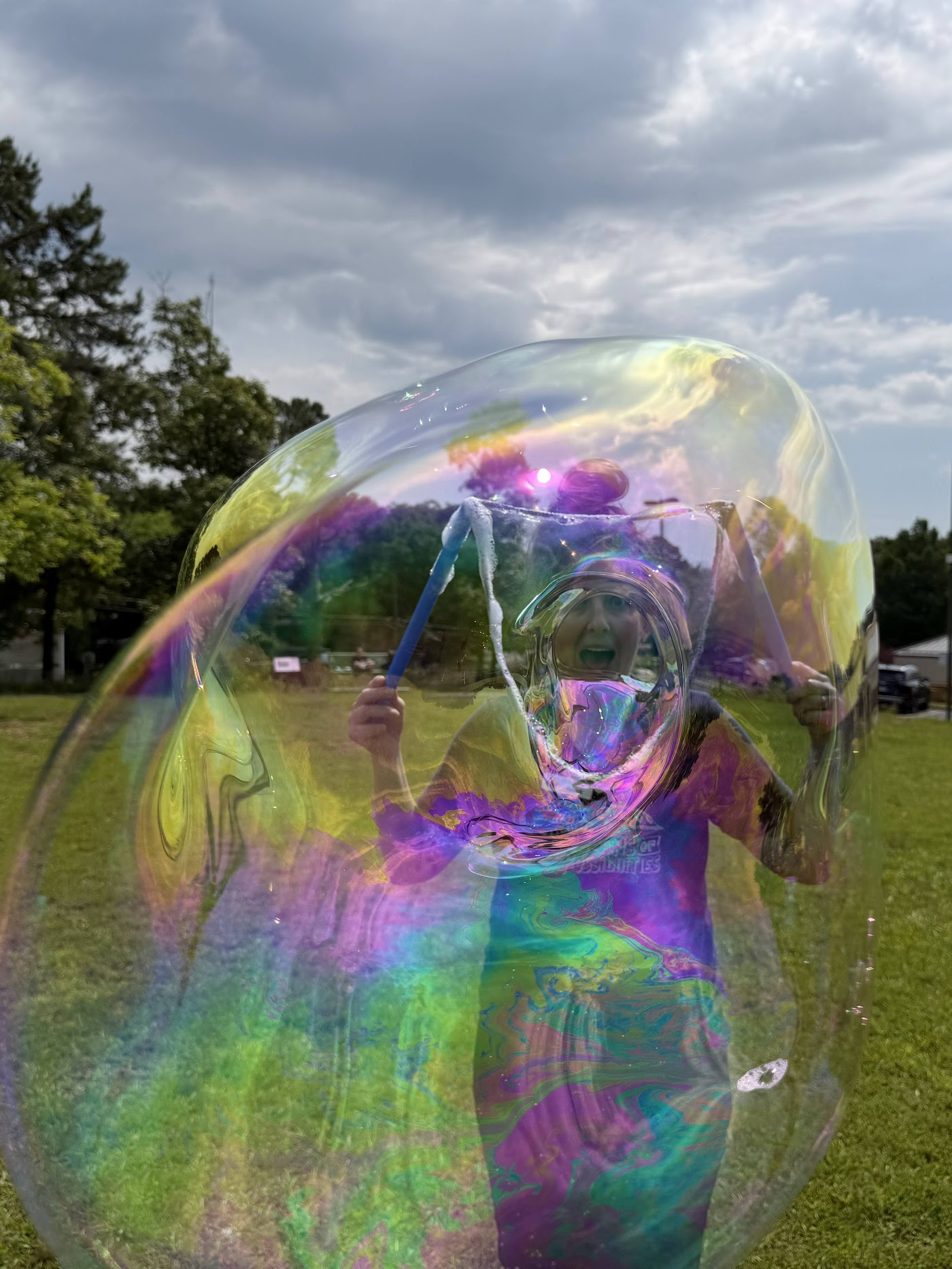 Ms. Brook looking through a large bubble